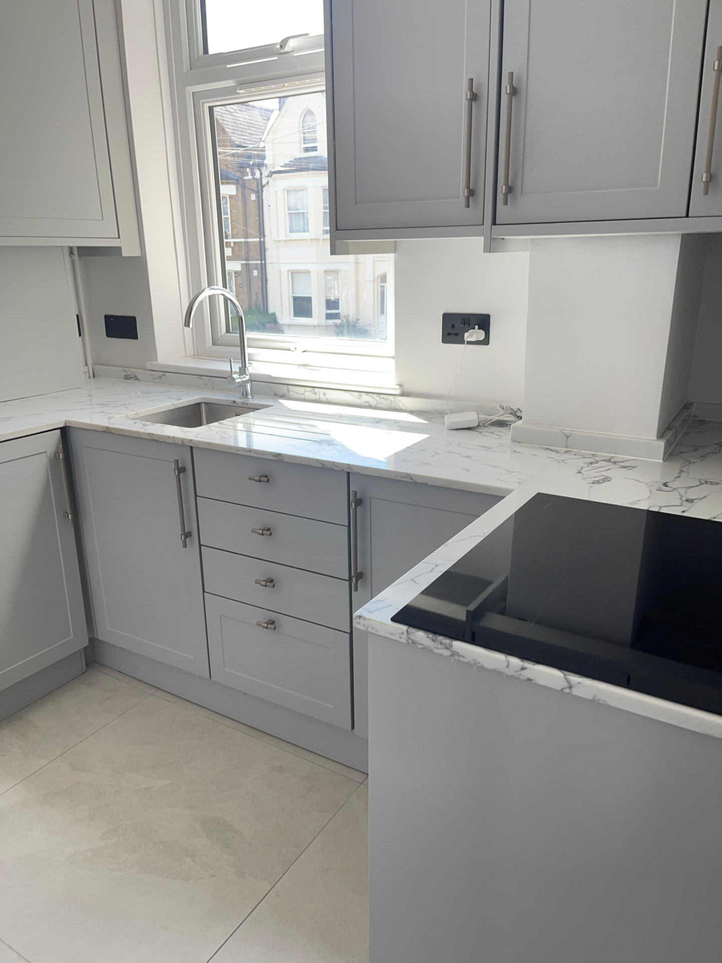 Grey shaker kitchen with marble worktop after a regular clean